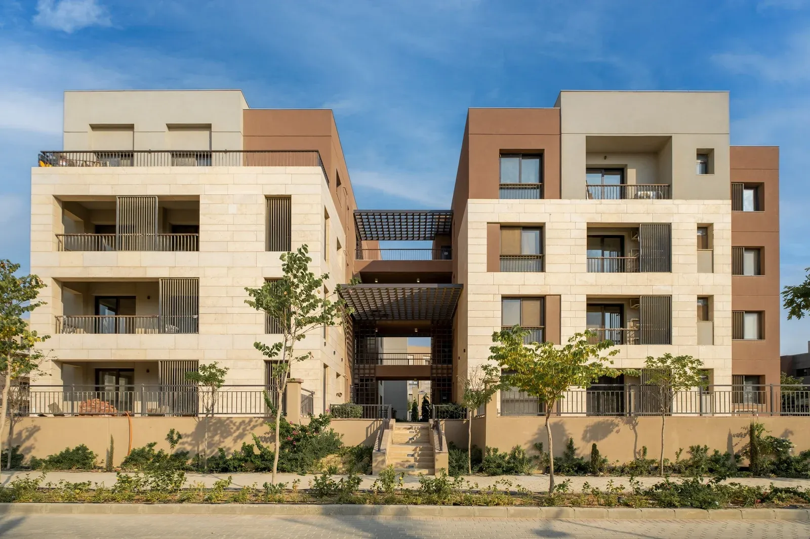 Four-storey residential building with a shaded entrance at District 5, New Cairo